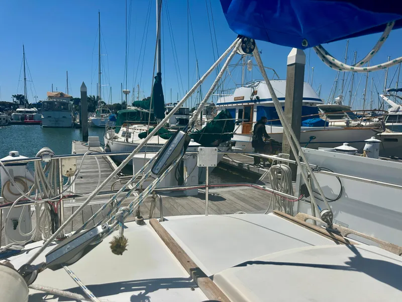 Slide: The Image of 1979 O'Day Center Cockpit sailboat docked at a marina under clear blue skies. - 30