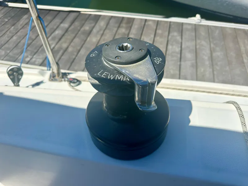 Slide: The Image of Winch on 1979 O'Day Center Cockpit sailboat, docked with visible deck and railing. - 31