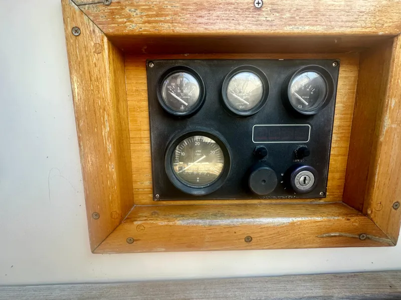 Slide: The Image of 1979 O'Day Center Cockpit control panel with wooden frame and gauges. - 36