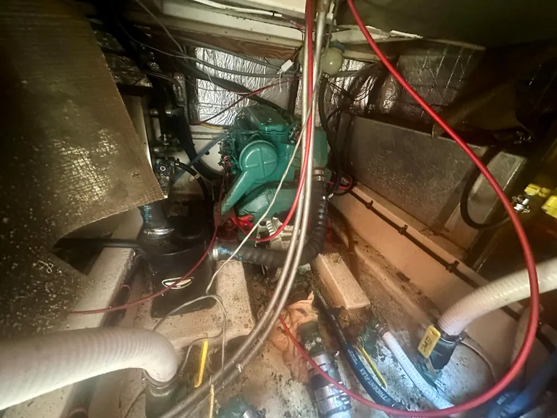 Slide: The Image of 1979 O'Day Center Cockpit engine room with visible wiring and mechanical components. - 38