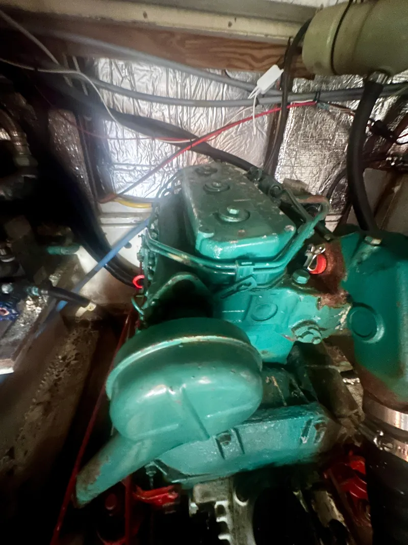 Slide: The Image of Engine of a 1979 O'Day Center Cockpit sailboat, showing mechanical components. - 40