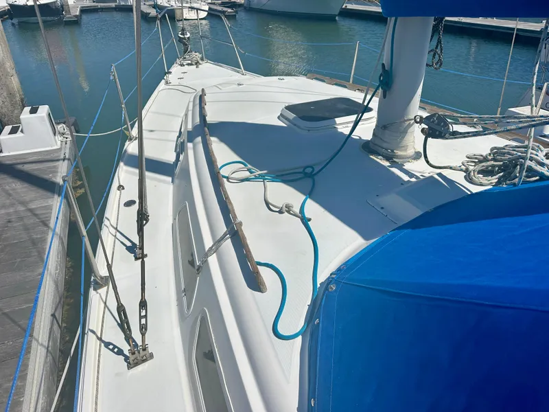 Slide: The Image of 1979 O'Day Center Cockpit sailboat docked, featuring a clean deck and blue sail cover. - 5