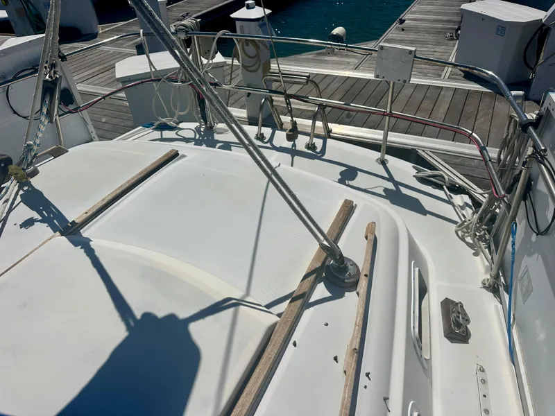 Slide: The Image of 1979 O'Day Center Cockpit sailboat deck at marina, featuring rigging and dock view. - 6
