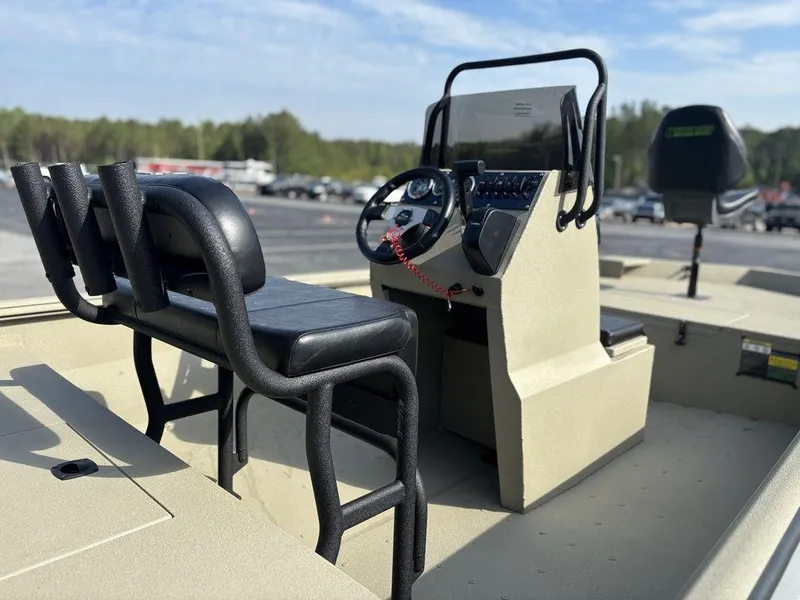 Slide: The Image of 2025 Havoc 1965 UCC boat interior with steering console and seating, outdoors. - 10