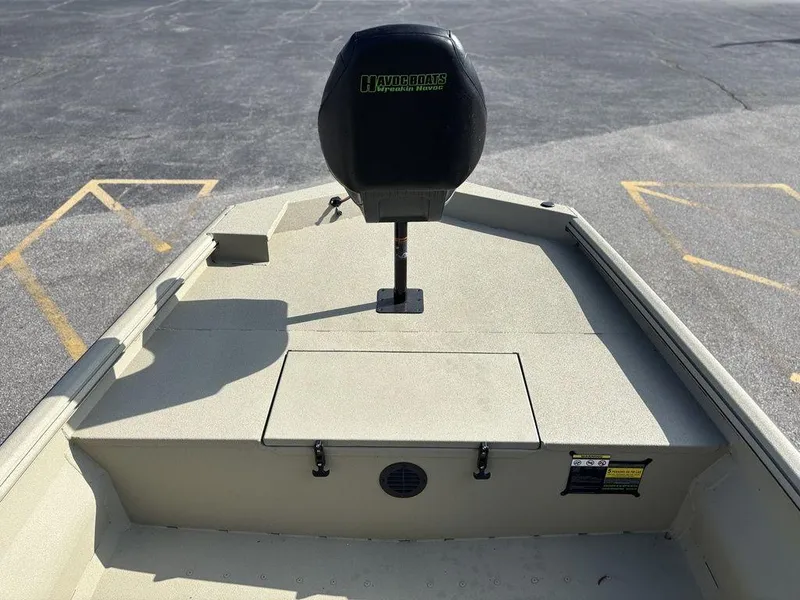 Slide: The Image of Boat interior with Havoc 1965 UCC model, 2025, featuring a mounted seat and storage compartment. - 12