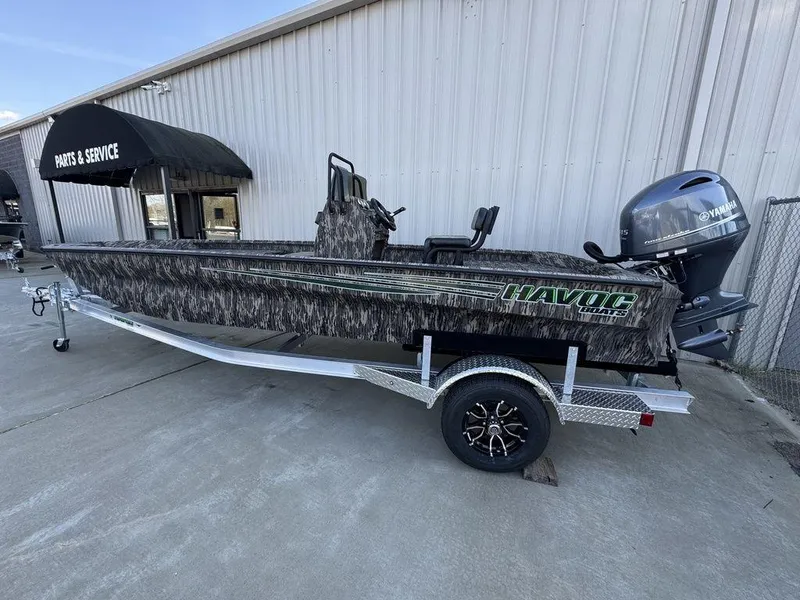 Slide: The Image of 2025 Havoc 1965 UCC boat on trailer, parked outside service center. - 14