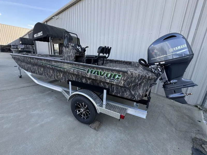 Slide: The Image of 2025 Havoc 1965 UCC boat with Yamaha motor on trailer, parked outdoors. - 15