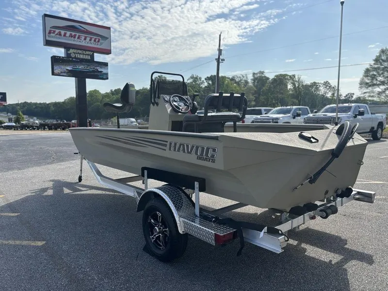 Slide: The Image of Havoc 1965 UCC boat on trailer, parked outdoors, sunny day, dealership sign in background. - 5