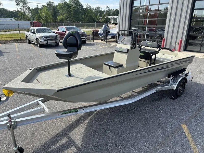 Slide: The Image of 2025 Havoc 1965 UCC boat on trailer, parked outside dealership, featuring modern design and seating. - 7