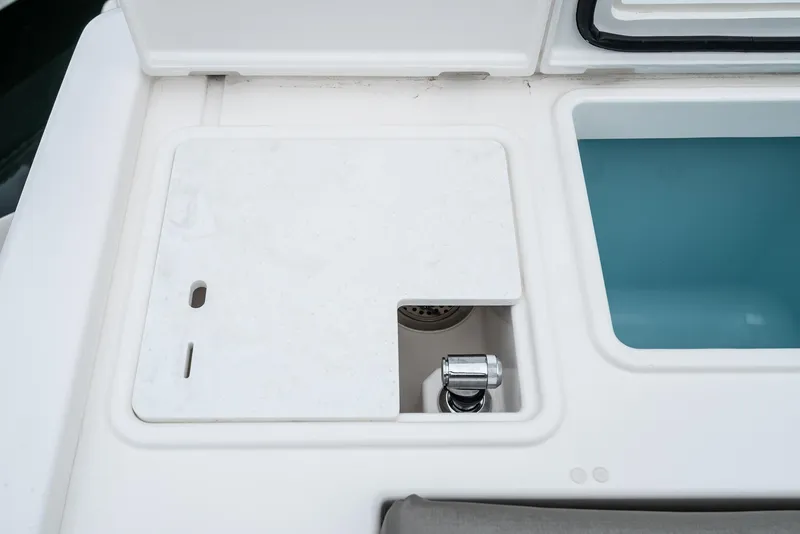 Slide: The Image of 2024 Tiara Yachts 34 LS deck detail with storage compartment and faucet. - 24
