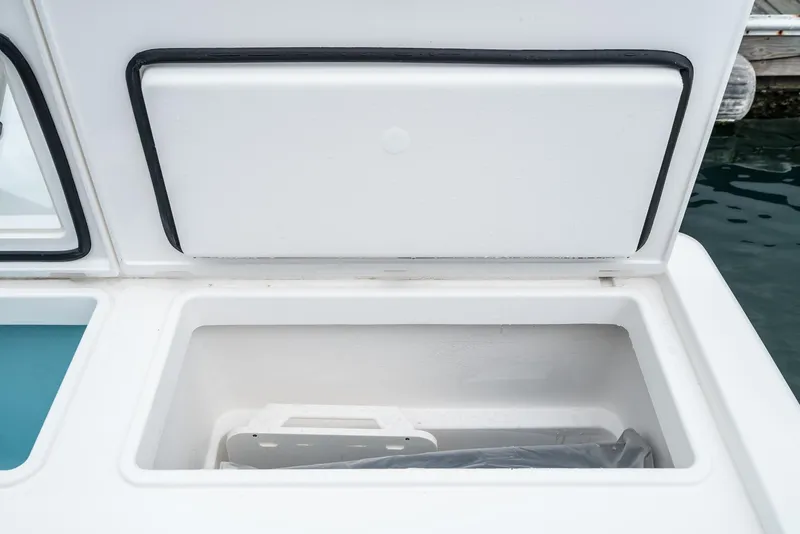 Slide: The Image of 2024 Tiara Yachts 34 LS storage compartment, open, showing interior details. - 26