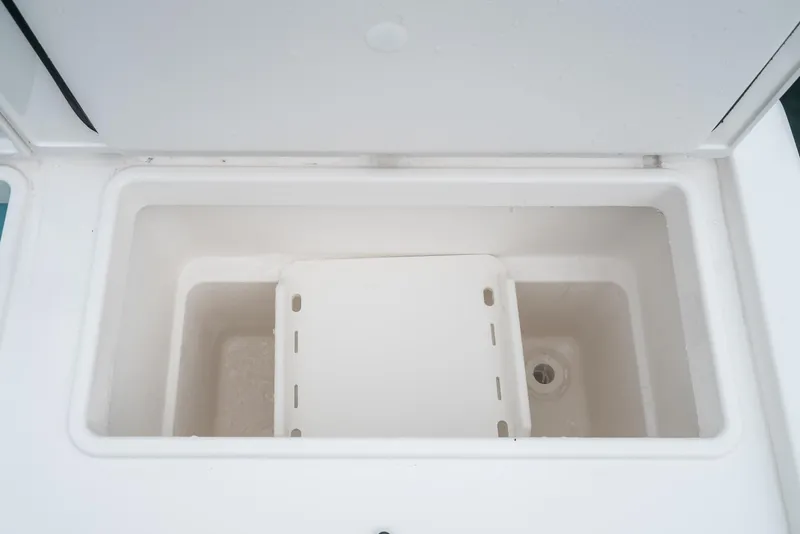 Slide: The Image of 2024 Tiara Yachts 34 LS storage compartment, open and empty, showcasing interior design. - 27