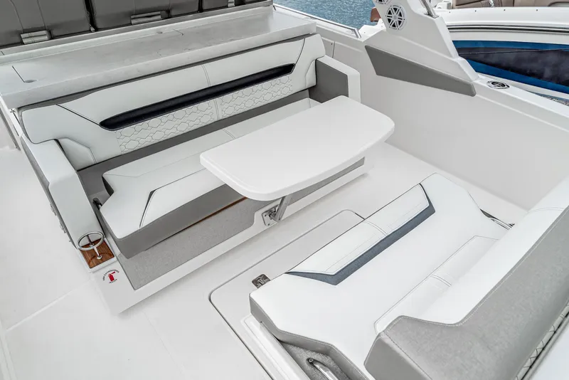 Slide: The Image of 2024 Tiara Yachts 34 LS interior with sleek seating and modern table design. - 29