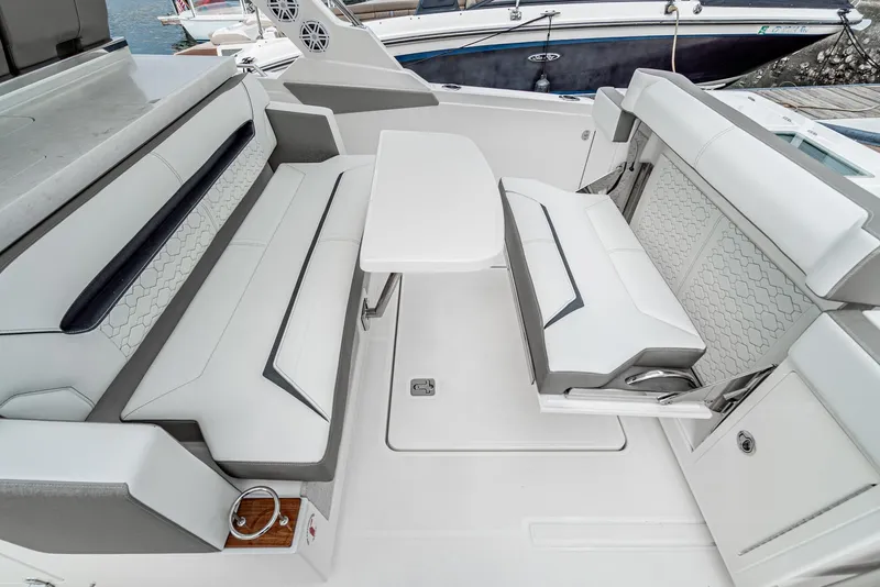 Slide: The Image of 2024 Tiara Yachts 34 LS interior seating with table, featuring modern design and comfortable upholstery. - 30