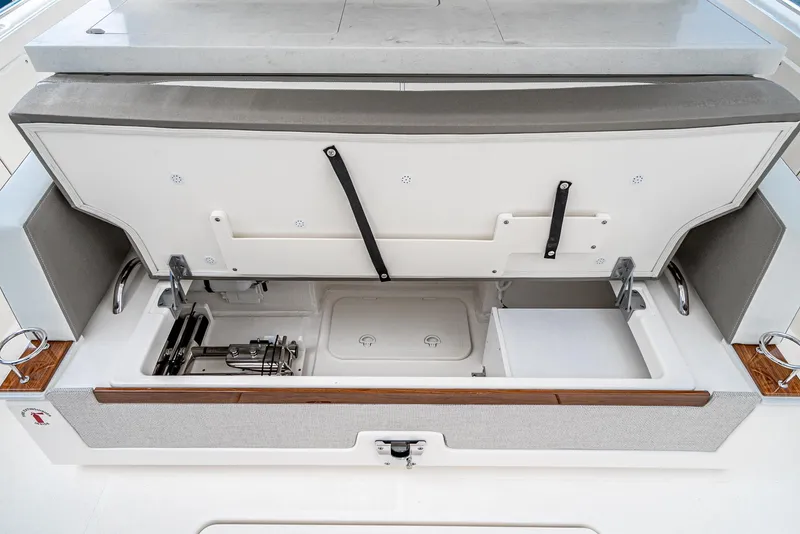 Slide: The Image of 2024 Tiara Yachts 34 LS storage compartment with open lid, showcasing organized interior space. - 33