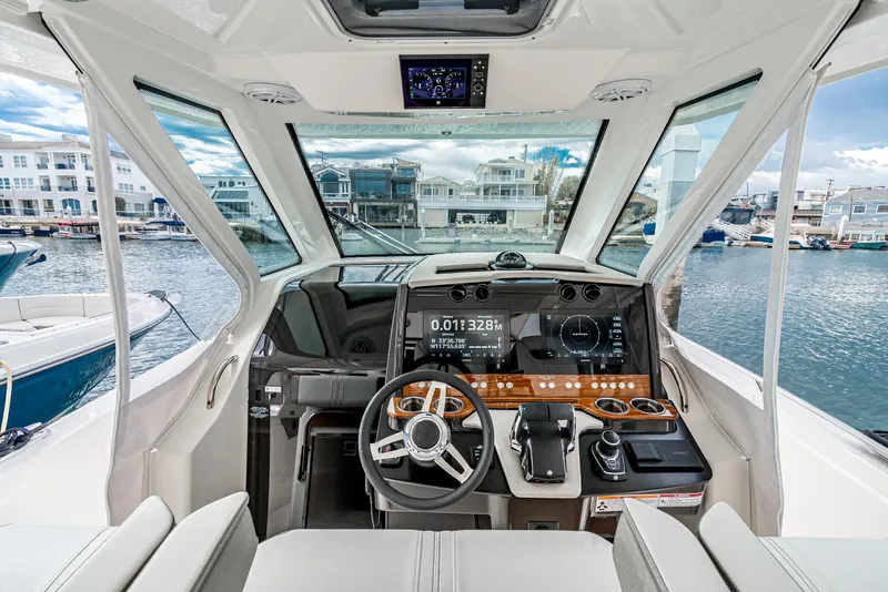 Slide: The Image of 2024 Tiara Yachts 34 LS helm with modern controls and waterfront view. - 38
