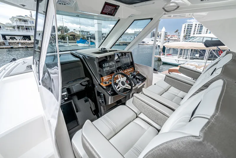 Slide: The Image of 2024 Tiara Yachts 34 LS helm with modern controls and luxurious seating. - 39