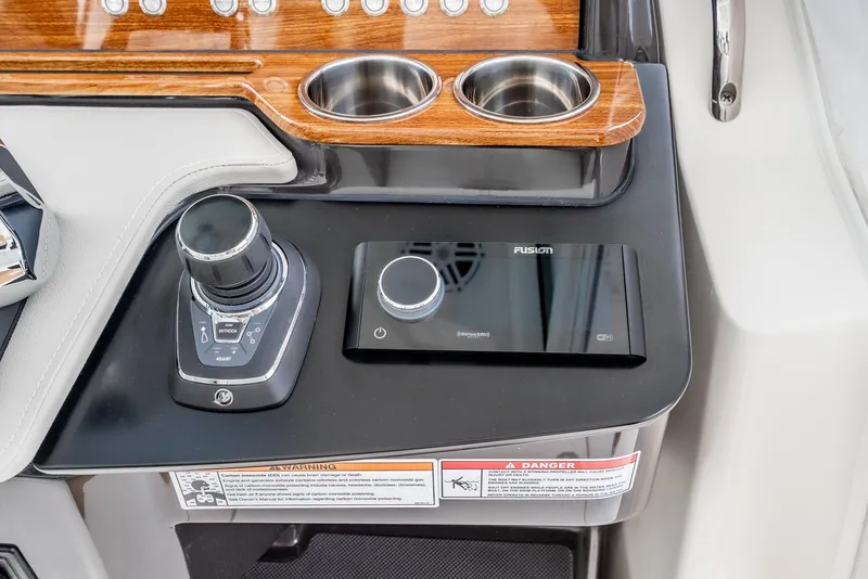 Slide: The Image of 2024 Tiara Yachts 34 LS dashboard with controls and cup holders. - 45
