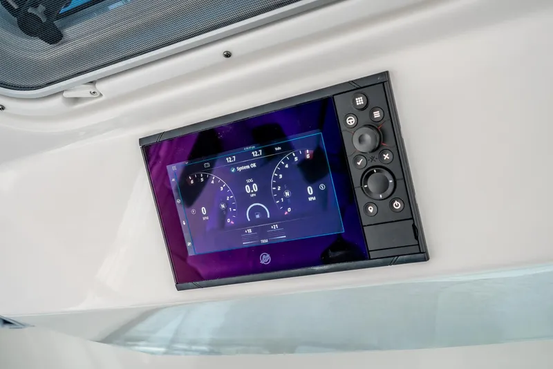Slide: The Image of 2024 Tiara Yachts 34 LS dashboard display with digital controls and gauges. - 46