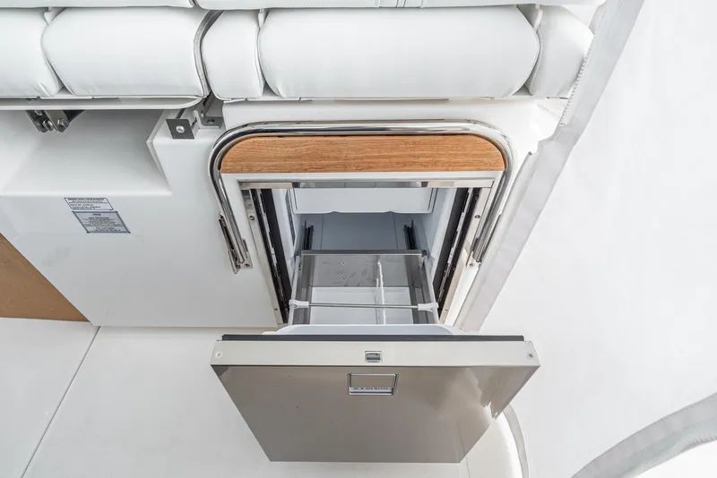 Slide: The Image of 2024 Tiara Yachts 34 LS interior drawer with wooden accents and white upholstery. - 48