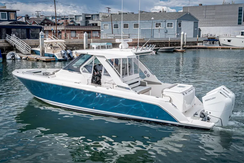 Slide: The Image of 2024 Tiara Yachts 34 LS in marina, showcasing sleek design and modern features. - 5