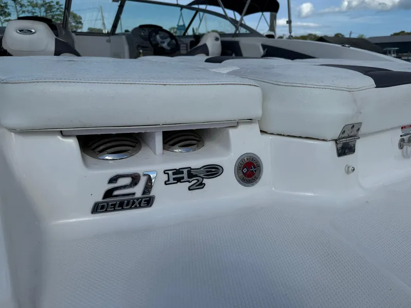 Slide: The Image of 2015 Chaparral 21 H2O Sport boat interior with deluxe seating and logo details. - 11