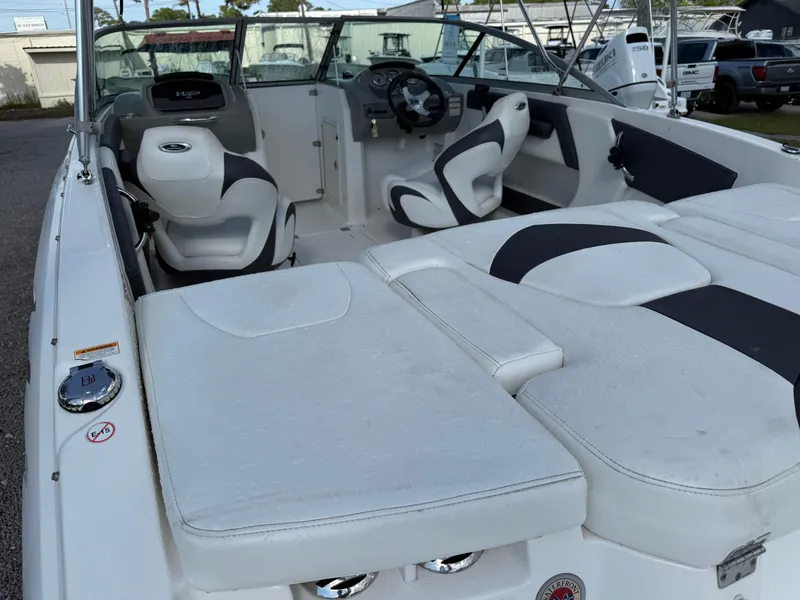 Slide: The Image of 2015 Chaparral 21 H2O Sport boat interior with white seating and steering console. - 12