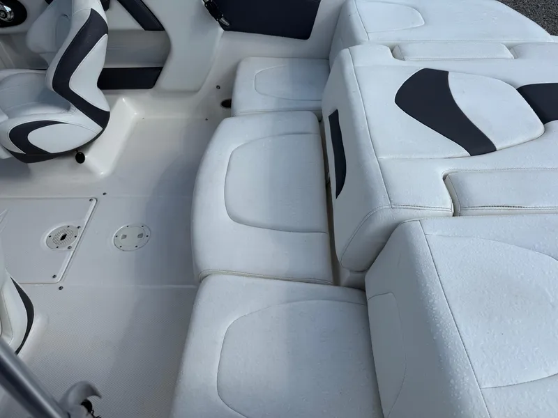 Slide: The Image of 2015 Chaparral 21 H2O Sport boat interior with white and black seating. - 13