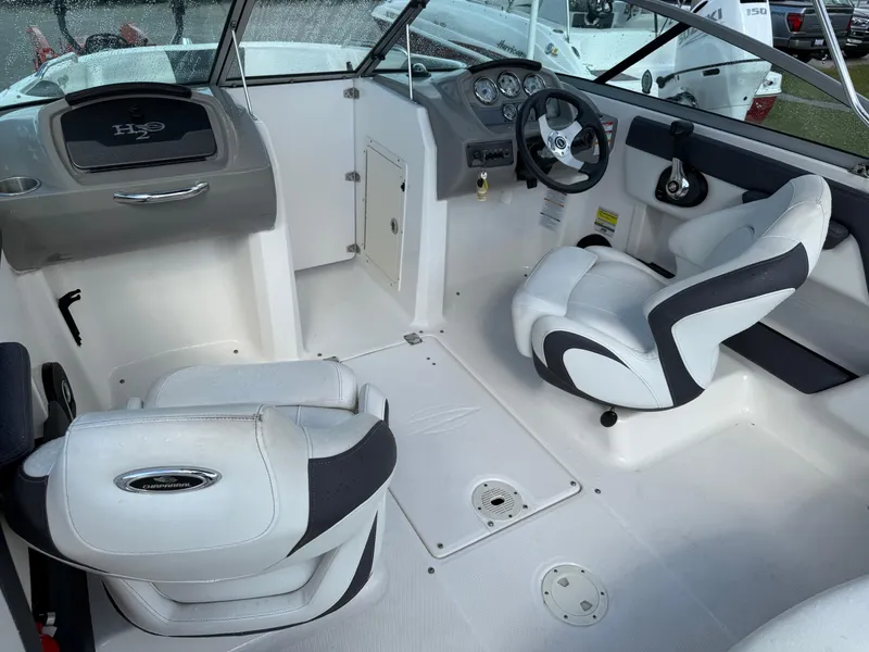 Slide: The Image of 2015 Chaparral 21 H2O Sport boat interior with white seating and dashboard. - 14