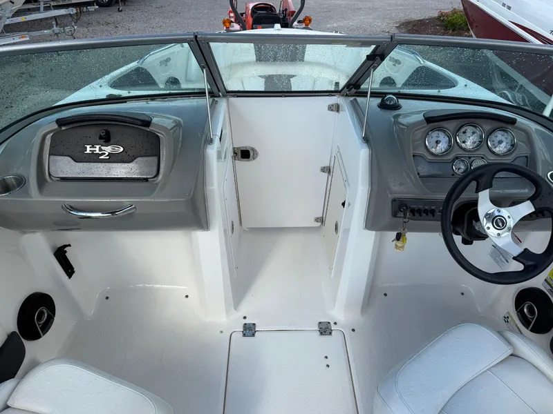 Slide: The Image of 2015 Chaparral 21 H2O Sport boat interior with steering wheel and dashboard controls. - 15