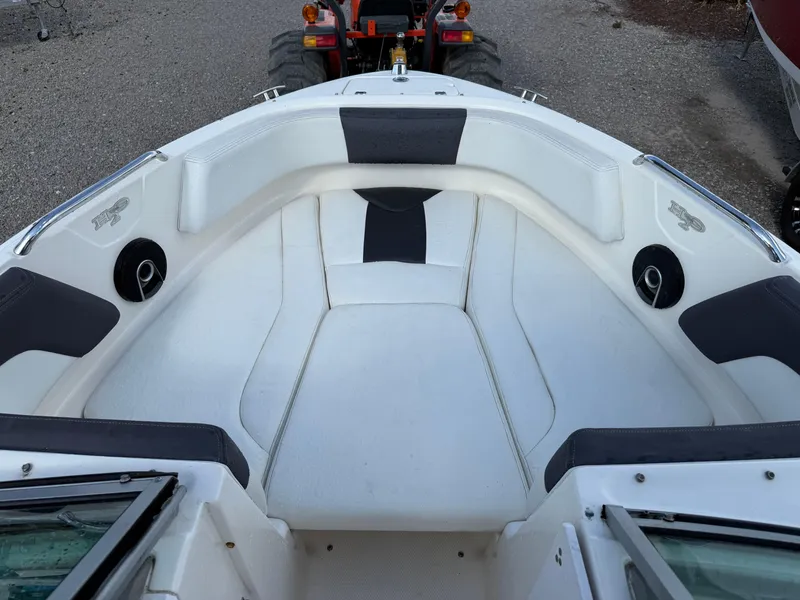 Slide: The Image of 2015 Chaparral 21 H2O Sport boat interior with cushioned seating and speakers. - 16