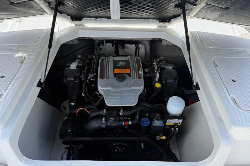 Slide: The Image of 2015 Chaparral 21 H2O Sport boat engine compartment with open hatch. - 20