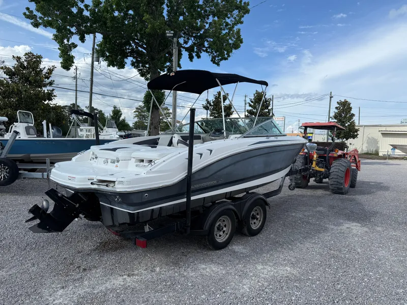 Slide: The Image of 2015 Chaparral 21 H2O Sport boat on trailer, parked outdoors. - 5