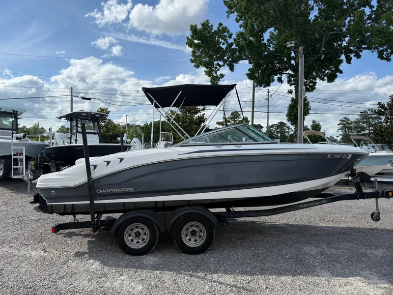 Slide: The Image of 2015 Chaparral 21 H2O Sport boat on trailer, parked outdoors. - 6