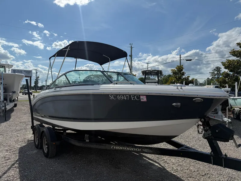 Slide: The Image of 2015 Chaparral 21 H2O Sport boat on trailer, parked outdoors under a sunny sky. - 7