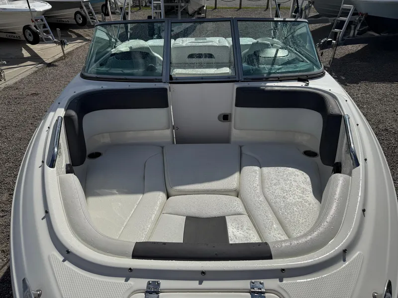 Slide: The Image of 2015 Chaparral 21 H2O Sport boat interior with white seating and windshield. - 8