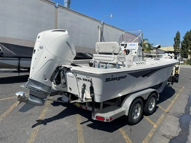 Slide: The Image of 2020 Ranger 2260 Bay boat on trailer, featuring powerful outboard motor. - 3