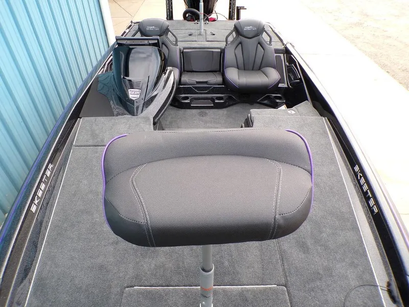 Slide: The Image of 2025 Skeeter ZXR20 boat interior with seating and carpeted deck. - 11