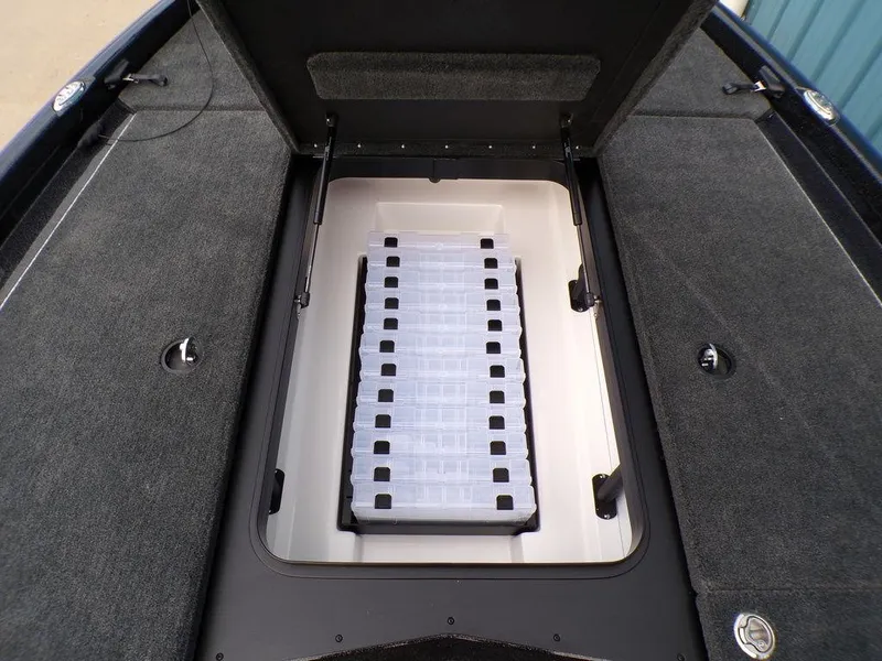 Slide: The Image of 2025 Skeeter ZXR20 boat storage compartment with open lid, showcasing interior design. - 13