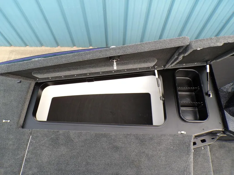 Slide: The Image of 2025 Skeeter ZXR20 boat storage compartment with open lid, showcasing interior space. - 14