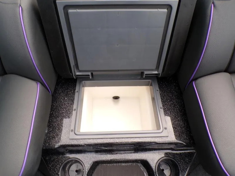 Slide: The Image of 2025 Skeeter ZXR20 boat storage compartment with cup holders and purple-trimmed seats. - 17