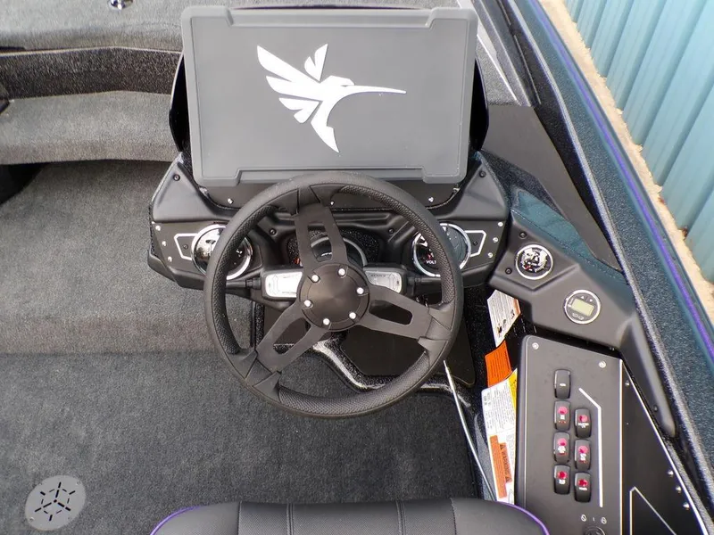 Slide: The Image of 2025 Skeeter ZXR20 boat dashboard with steering wheel and control panel. - 18