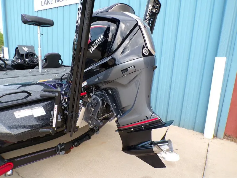 Slide: The Image of 2025 Skeeter ZXR20 boat with Yamaha outboard motor, parked near blue building. - 4