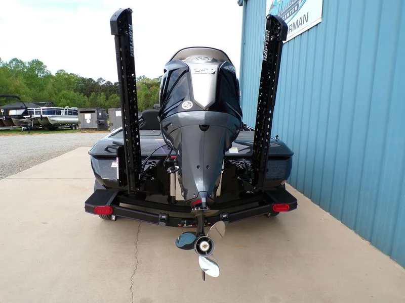 Slide: The Image of 2025 Skeeter ZXR20 boat rear view with motor and dual power poles. - 5