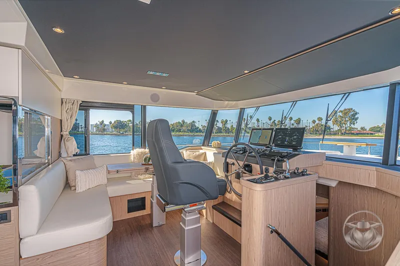 Slide: The Image of 2026 Beneteau Swift Trawler 54 cruising on a serene river with lush greenery. - 21