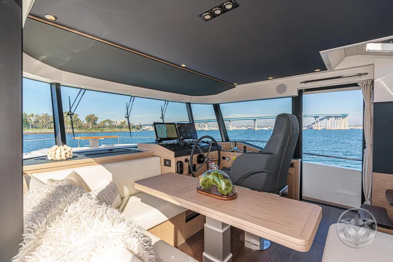 Slide: The Image of 2026 Beneteau Swift Trawler 54 helm with modern navigation displays and controls. - 23