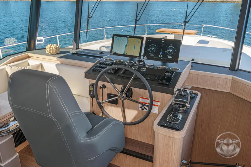 Slide: The Image of Helm of 2026 Beneteau Swift Trawler 54 with advanced navigation displays and controls. - 24