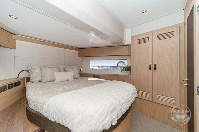 Slide: The Image of Luxurious bedroom interior of 2026 Beneteau Swift Trawler 54 with modern wood finishes. - 33