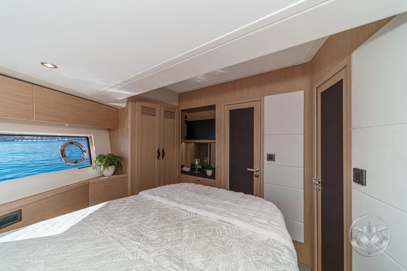 Slide: The Image of Luxurious interior of 2026 Beneteau Swift Trawler 54 with TV, plants, and elegant decor. - 34