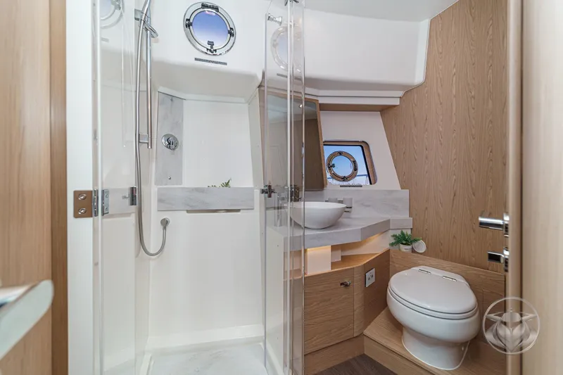 Slide: The Image of Interior cabin of 2026 Beneteau Swift Trawler 54 with bunk beds and porthole windows. - 38